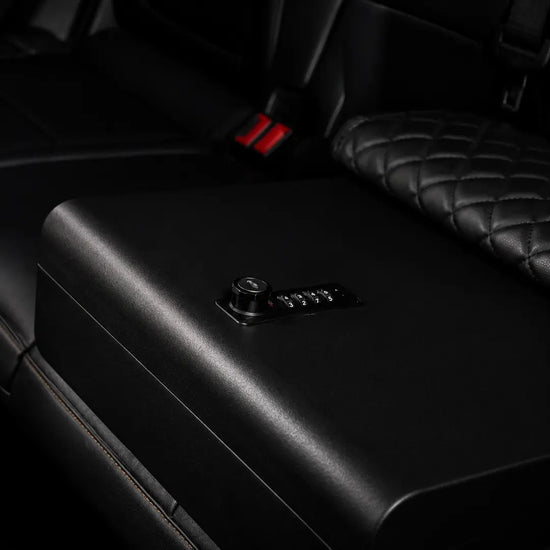 Open Boosted Safe installed on a truck rear seat with foam-lined storage compartment for valuables.