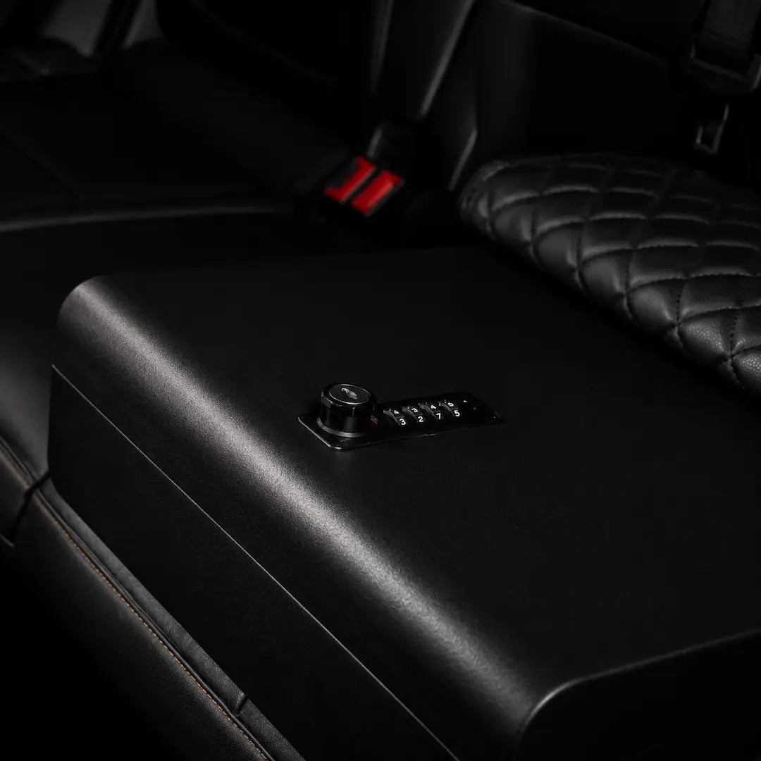 Open Boosted Safe installed on a truck rear seat with foam-lined storage compartment for valuables.