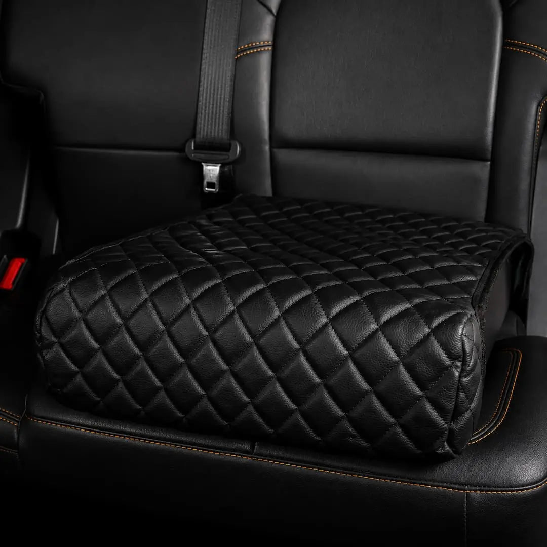 Quilted leather booster seat cover disguising the Boosted Safe on a vehicle rear seat.