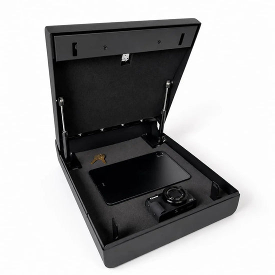 Open Boosted Safe with foam interior storing a tablet, camera, and keys inside the secure compartment.
