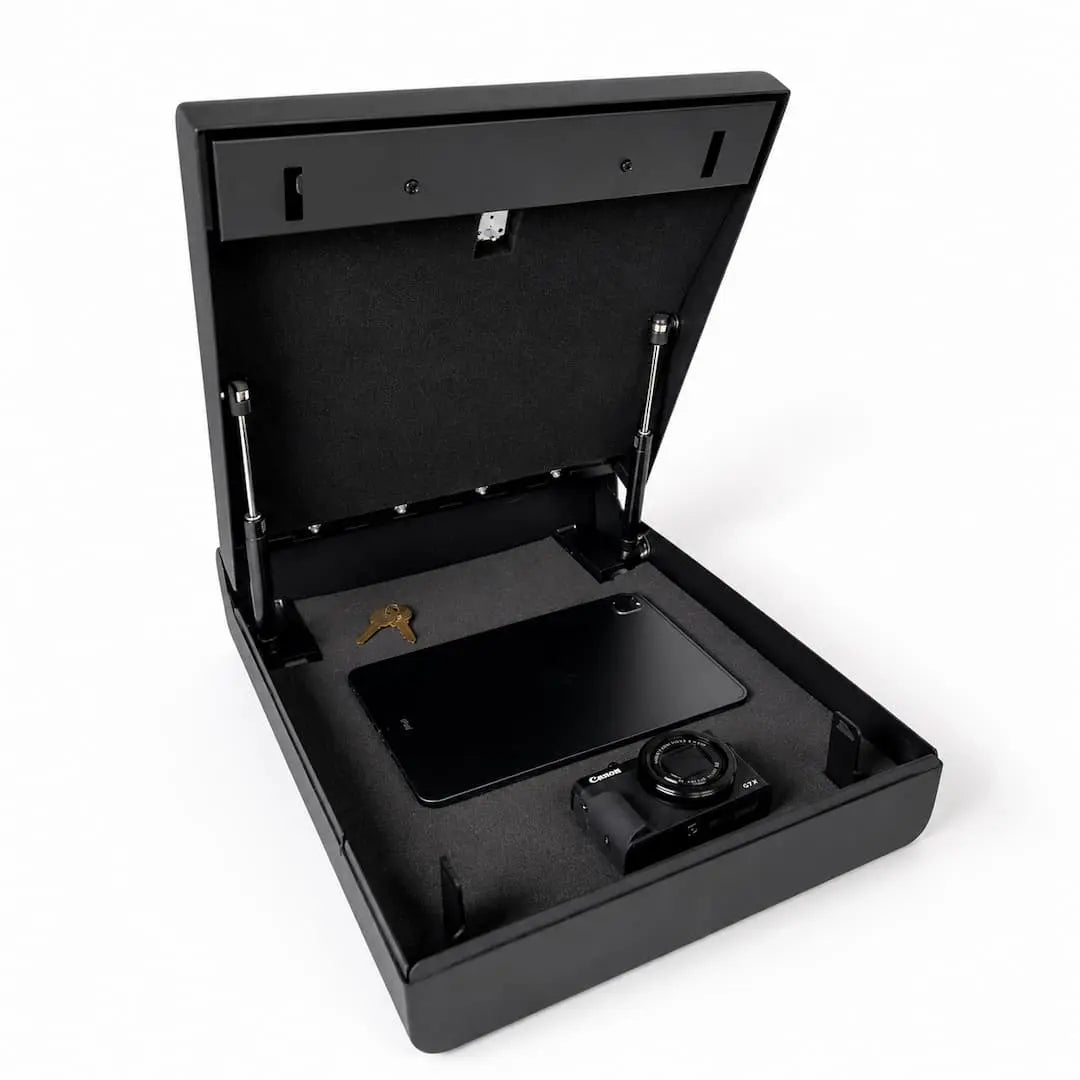 Open Boosted Safe with foam interior storing a tablet, camera, and keys inside the secure compartment.