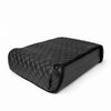 Quilted leather booster seat cover fitted over the Boosted Safe in a clean studio product shot.