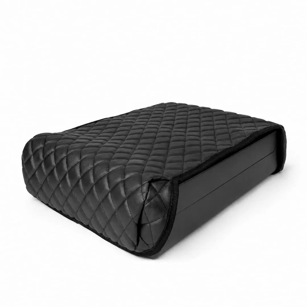 Quilted leather booster seat cover fitted over the Boosted Safe in a clean studio product shot.