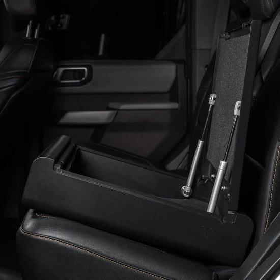 BoostedSafe Elite open hidden car safe with steel construction and gas strut lid supports installed in vehicle rear seat.