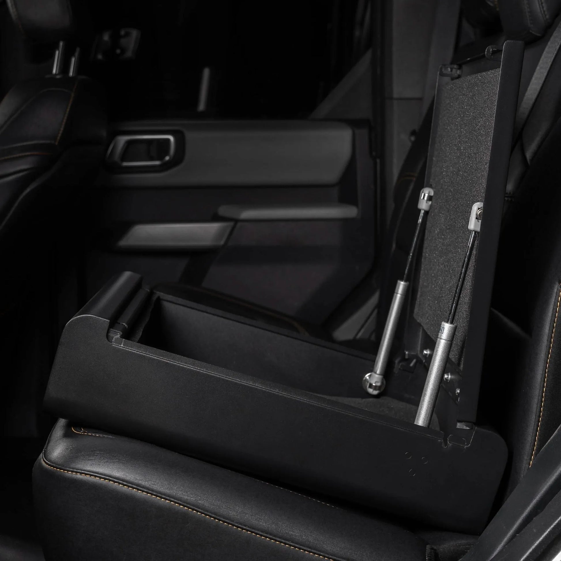 BoostedSafe Elite open hidden car safe with steel construction and gas strut lid supports installed in vehicle rear seat.
