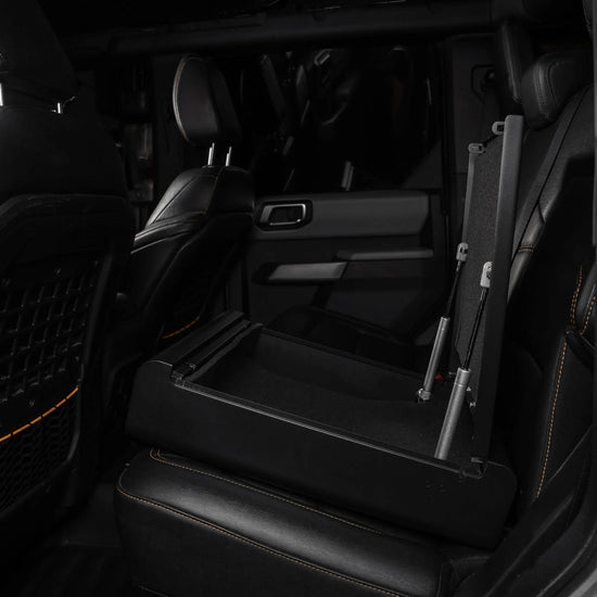 Boosted Safe Elite hidden rear seat safe with open steel storage compartment and gas-assisted lid.