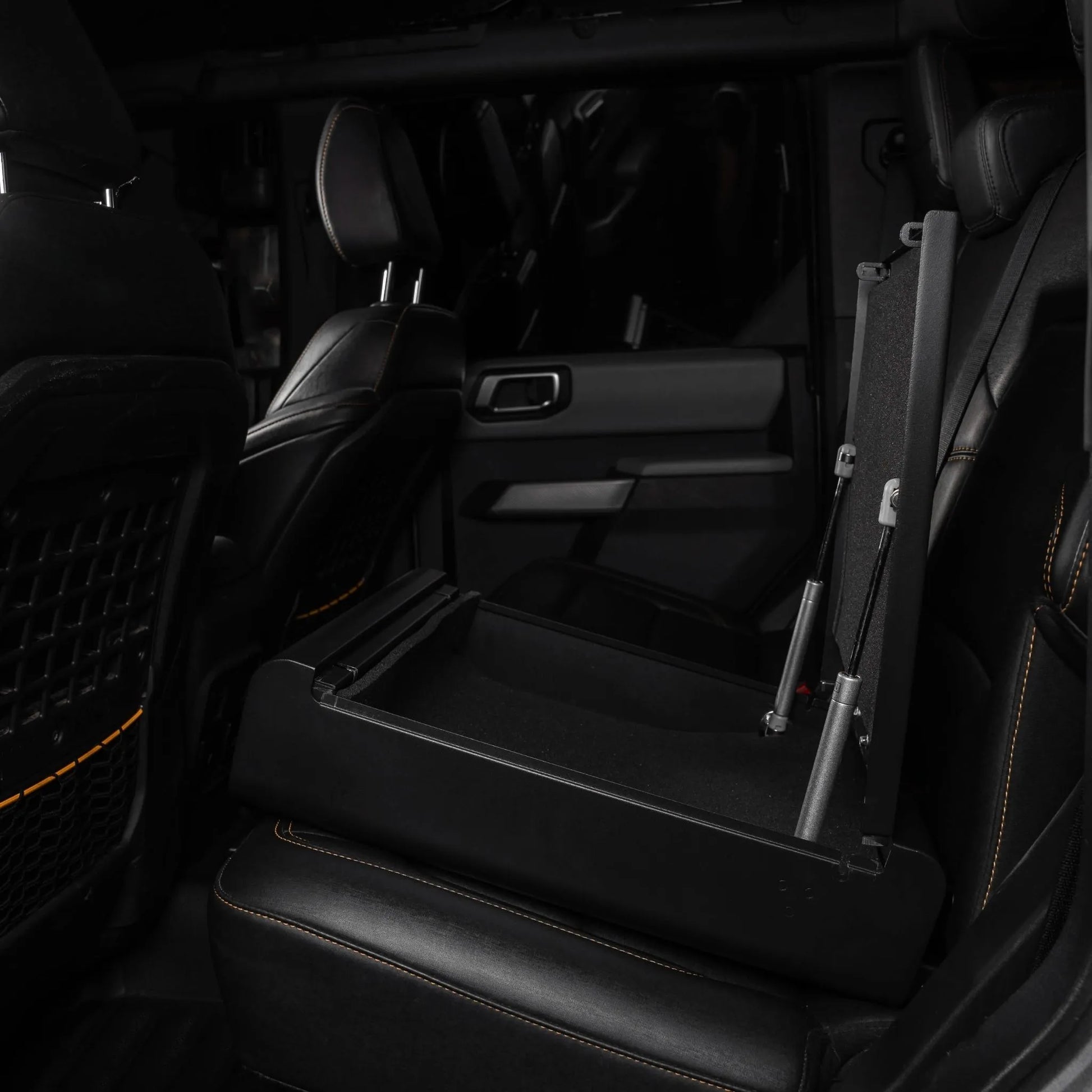Boosted Safe Elite hidden rear seat safe with open steel storage compartment and gas-assisted lid.