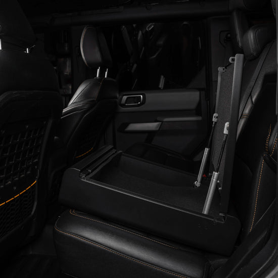 BoostedSafe Elite open showing pneumatic lid in truck rear seat install