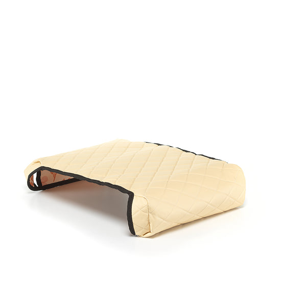 Beige reversible BoostedSafe cover showing quilted exterior and floral print underside.