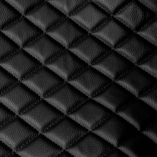 Close-up texture of the black quilted leather-style BoostedSafe booster seat cover.
