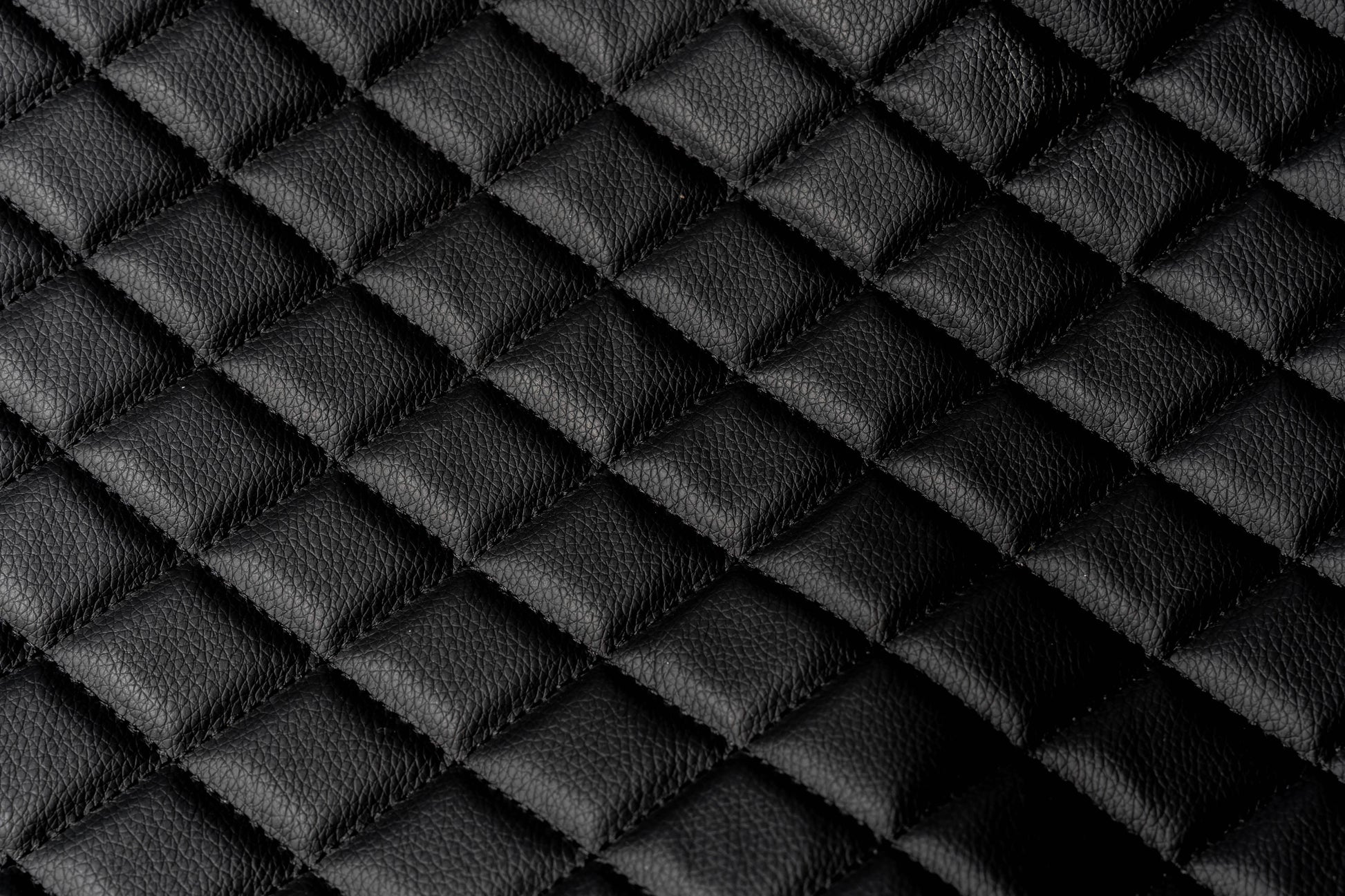 Close-up texture of the black quilted leather-style BoostedSafe booster seat cover.
