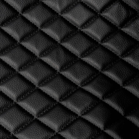 Black quilted leather texture detail on BoostedSafe Elite hidden vehicle safe cover.