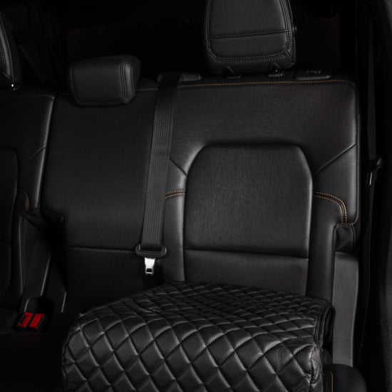 BoostedSafe Elite disguised as a black quilted booster seat cover in a rear SUV seat.
