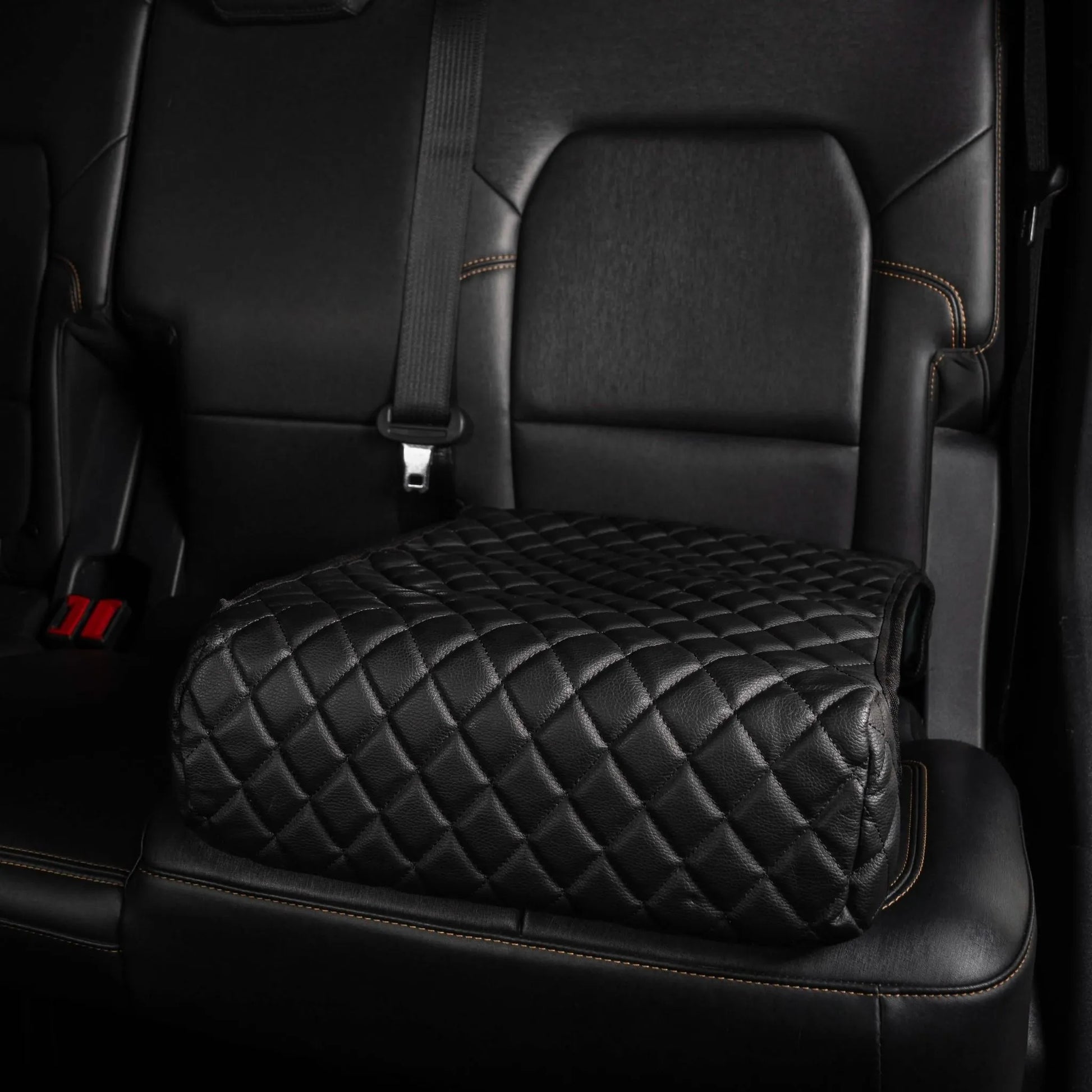 BoostedSafe Elite hidden car safe disguised as a black quilted booster seat in vehicle interior.