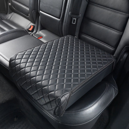 Boosted Safe Elite concealed vehicle safe with quilted leather cover installed on rear passenger seat.