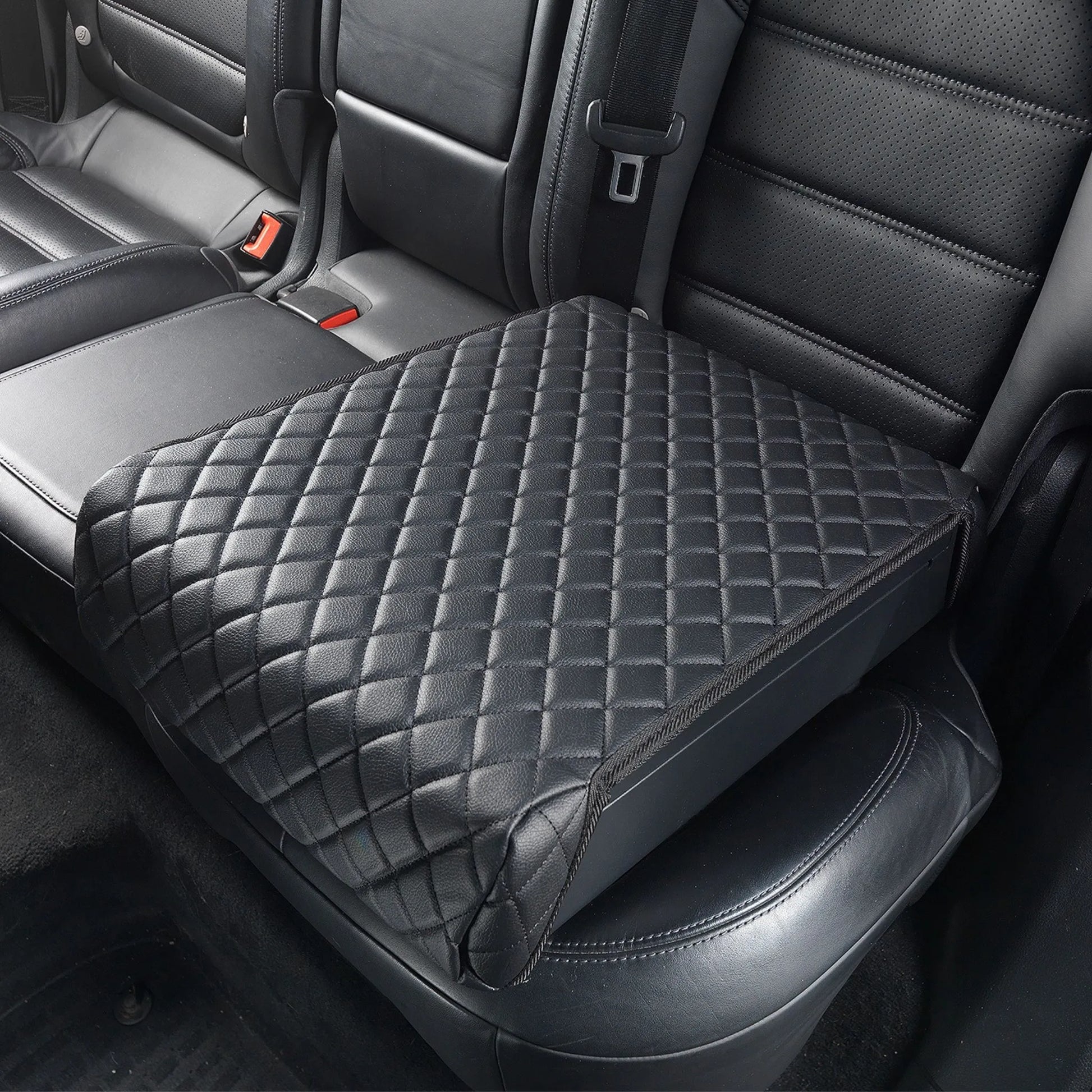Boosted Safe Elite concealed vehicle safe with quilted leather cover installed on rear passenger seat.
