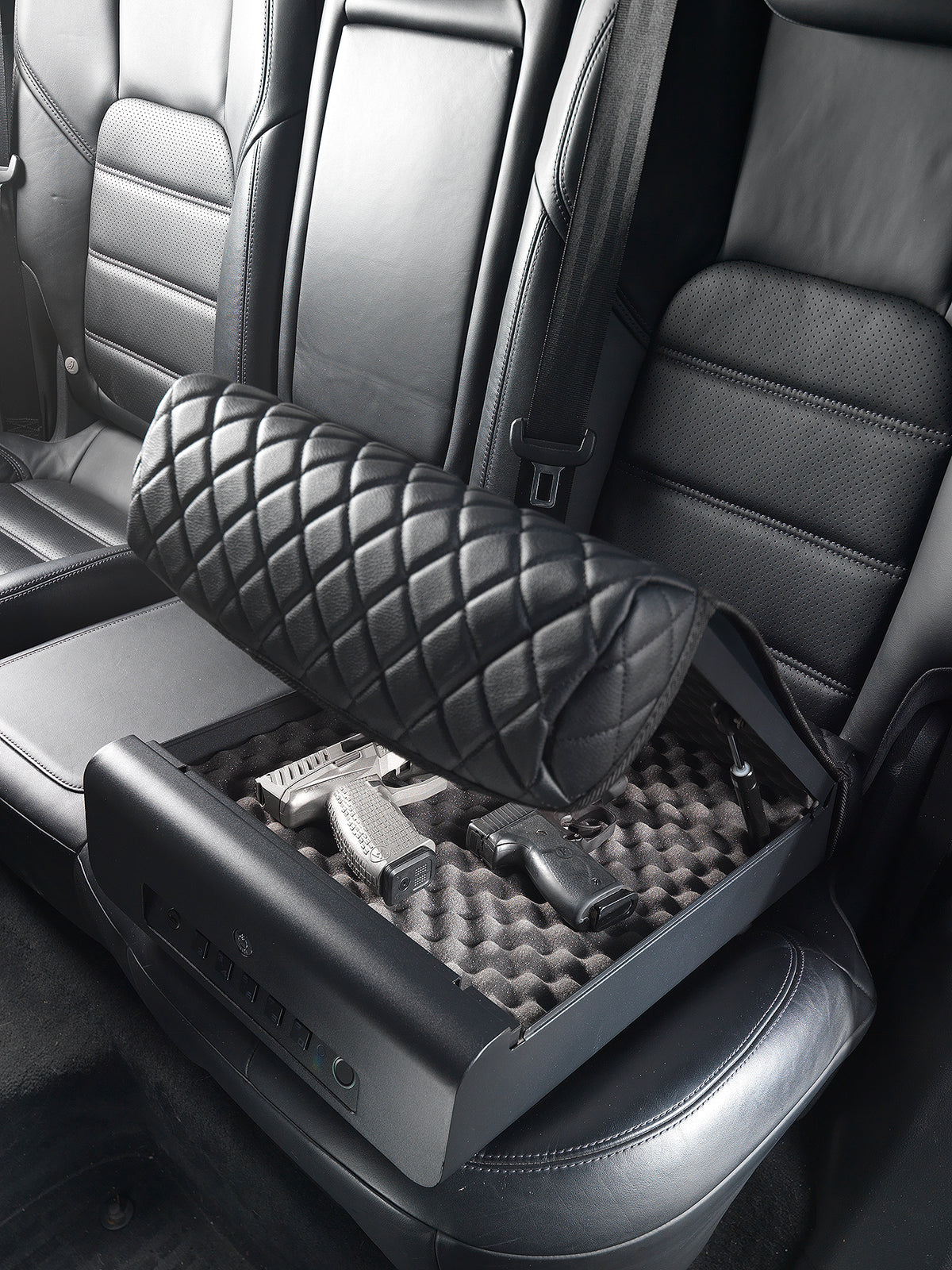 BoostedSafe Elite partially closing over two handguns in the foam-lined interior.