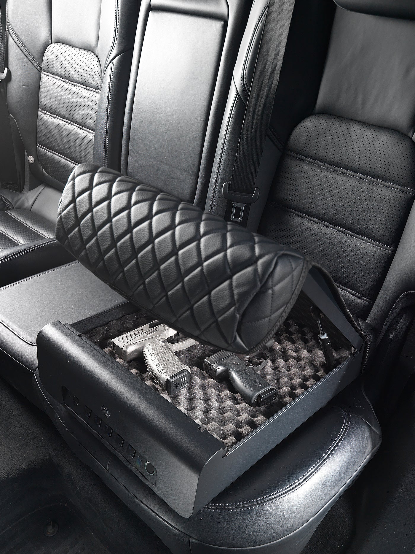 BoostedSafe Elite partially closing over two handguns in the foam-lined interior.