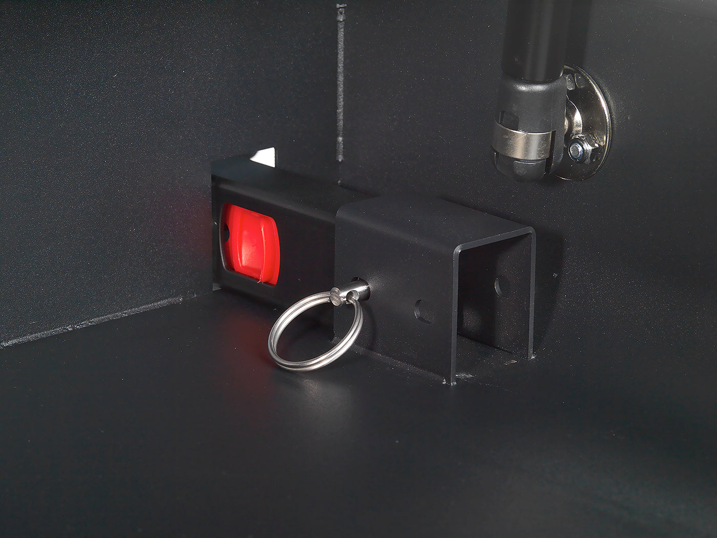 Interior close-up of BoostedSafe Elite ISOFIX release latch and locking pin.