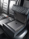 Open BoostedSafe Elite storing a laptop on foam padding in a rear vehicle seat.