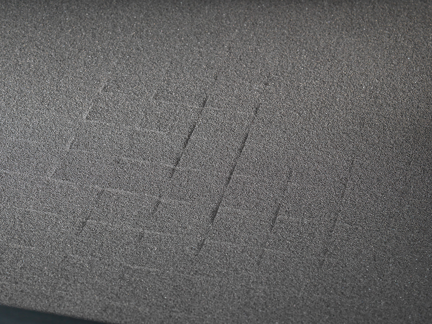 Close-up of BoostedSafe Elite modular foam insert with pre-cut grid for custom storage.