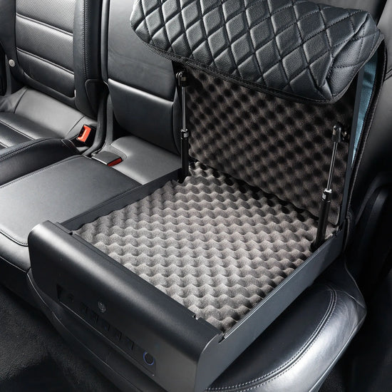 Boosted Safe Elite open on a rear vehicle seat with padded foam-lined interior and quilted booster seat disguise cover.