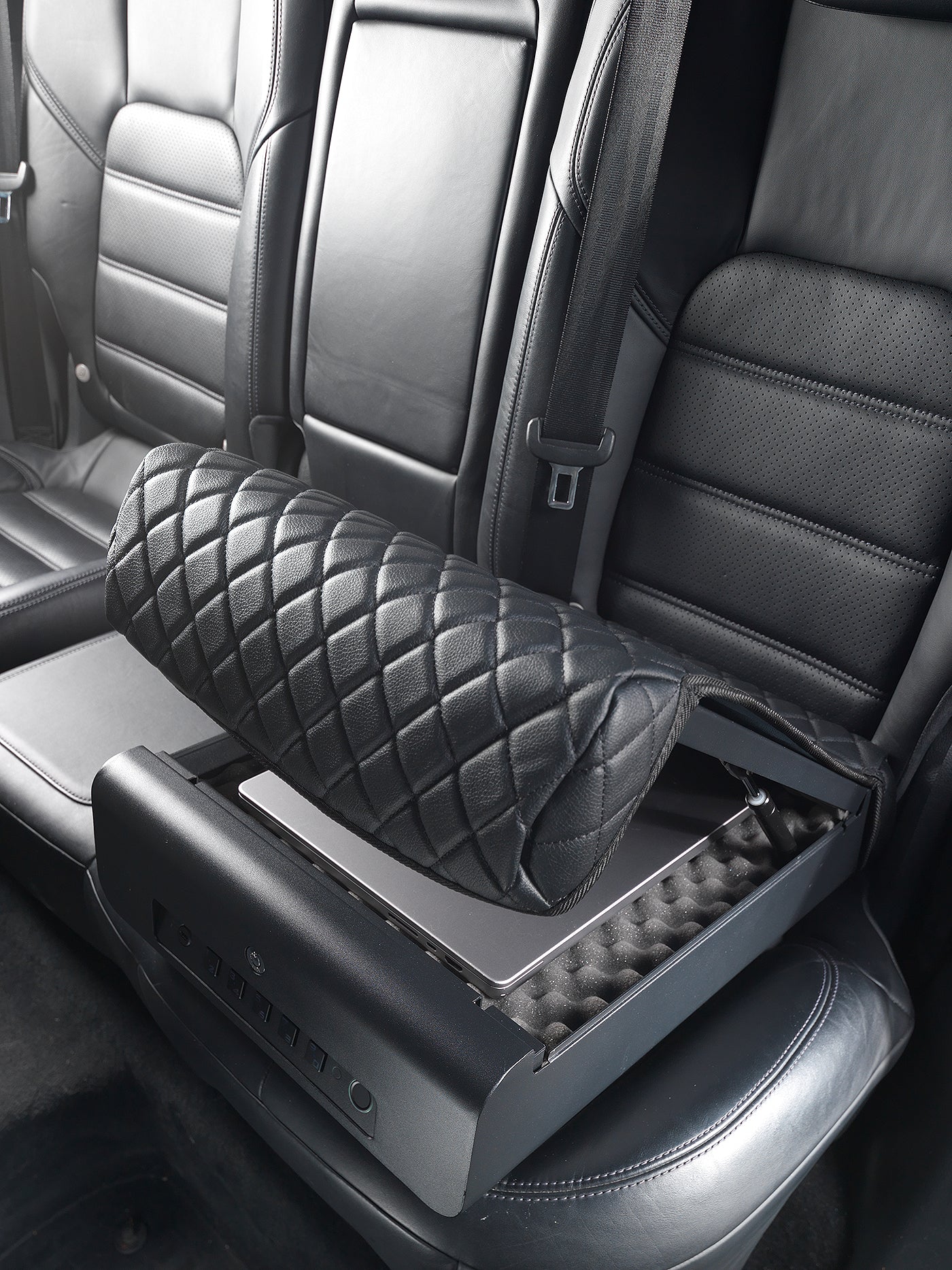 BoostedSafe Elite open on rear vehicle seat with a laptop stored inside.