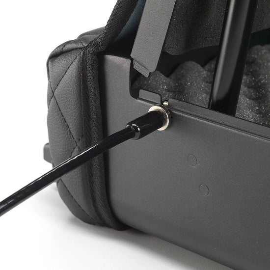 Close-up of the BoostedSafe Elite security cable connected to the side anchor point with the safe opened.