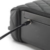 Close-up of the BoostedSafe Elite security cable attached to the side locking point beside the quilted booster seat cover.