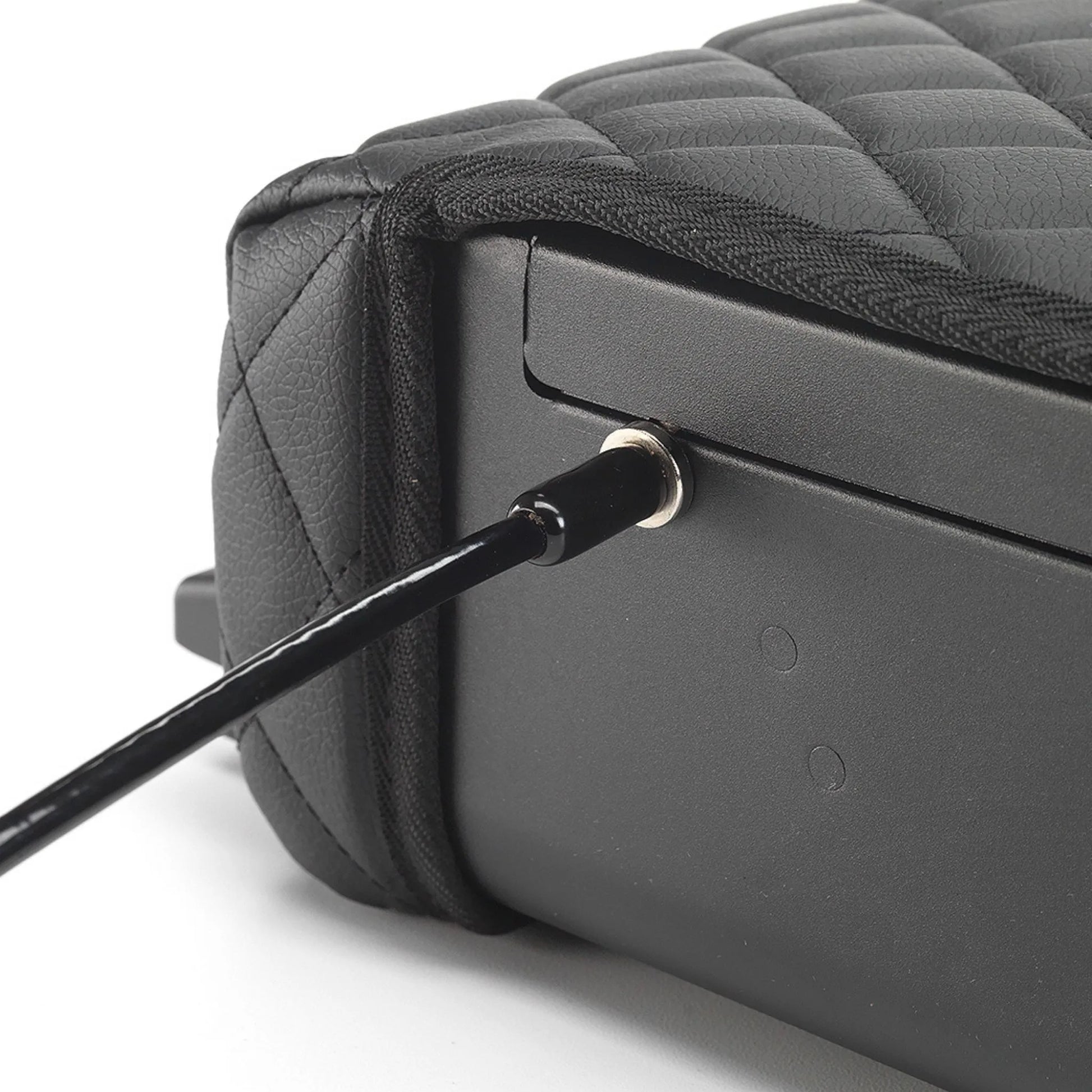 Close-up of the BoostedSafe Elite security cable attached to the side locking point beside the quilted booster seat cover.