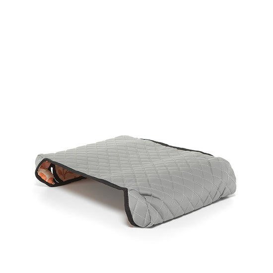 Gray reversible BoostedSafe cover showing quilted exterior and floral print underside.