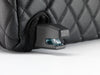 ISOFIX connector close-up protruding through the black quilted BoostedSafe cover.