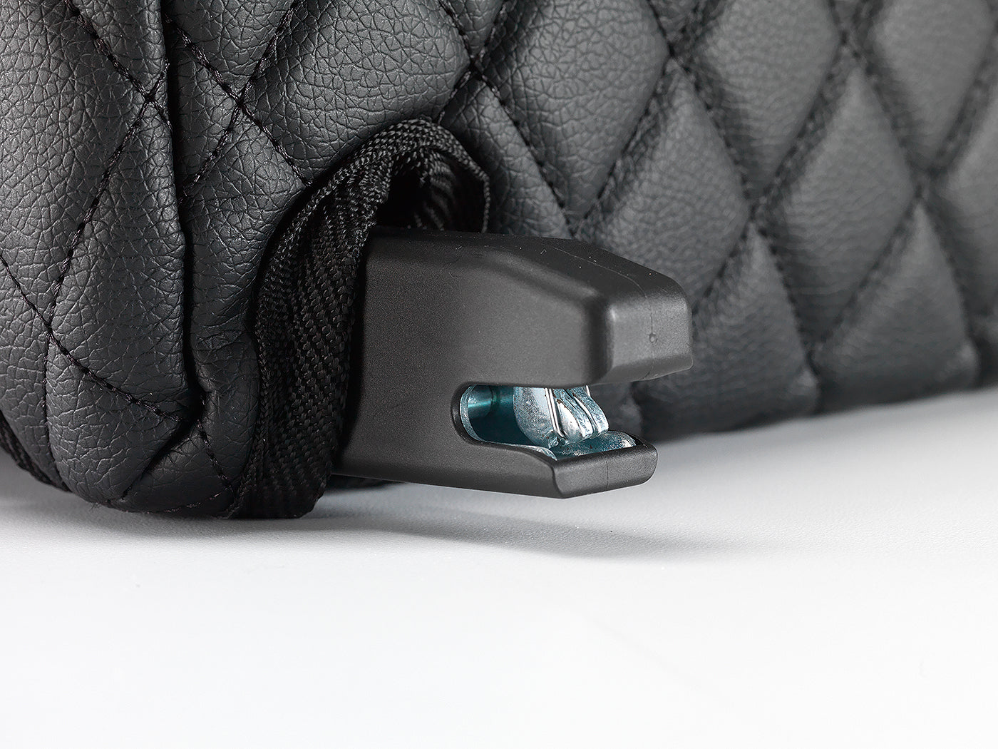 ISOFIX connector close-up protruding through the black quilted BoostedSafe cover.