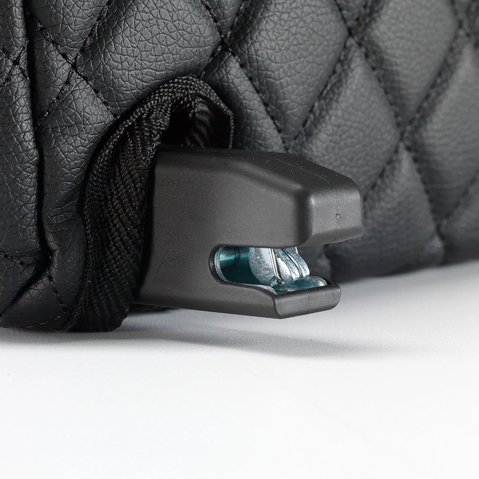 Close-up of the BoostedSafe Elite ISOFIX connector attached beside the quilted booster seat disguise cover.