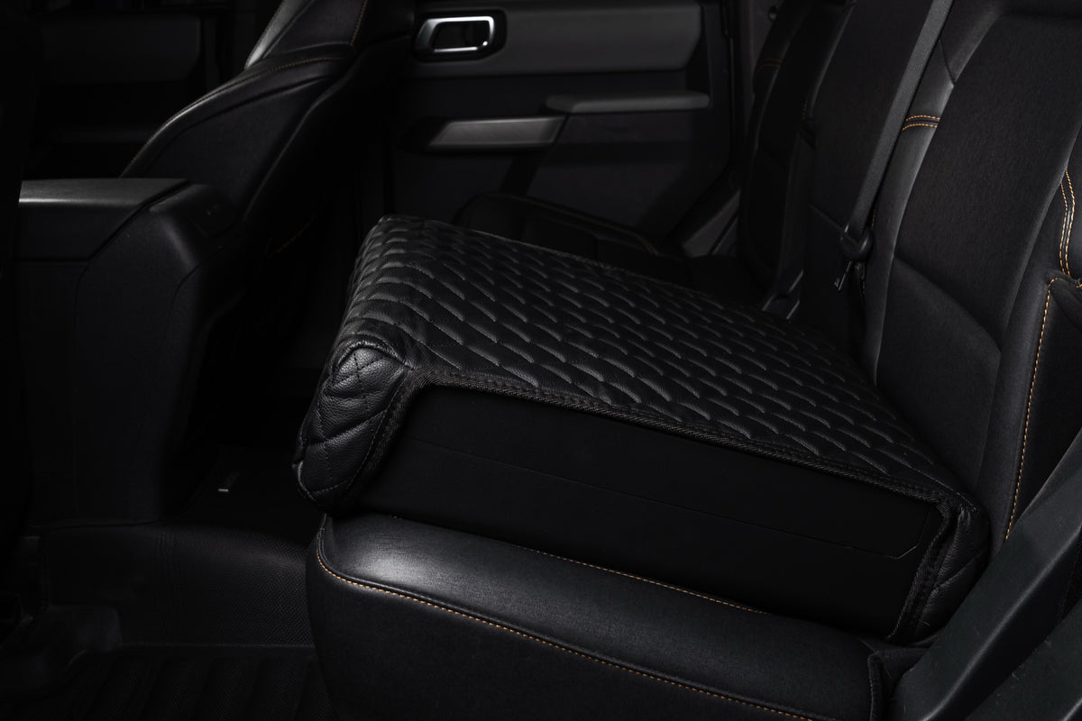 Closed Boosted Safe with its quilted leather top sitting on a truck's back seat