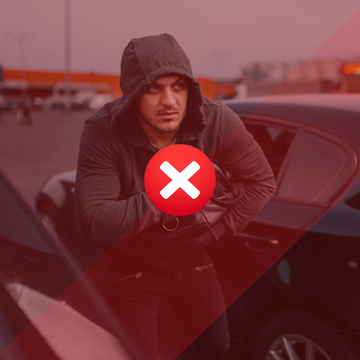 Hooded thief beside a vehicle, showing the risk of leaving a car unsecured.